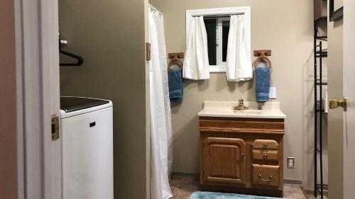 a bathroom with a sink and a mirror at Nugget Place-Includes three separate two bedroom units near Mendenhall Glacier-DISCOUNTS ON TOURS! in Mendenhaven