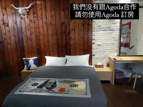 a bedroom with a bed with a dollar bill on it at Original Bnb in Tainan