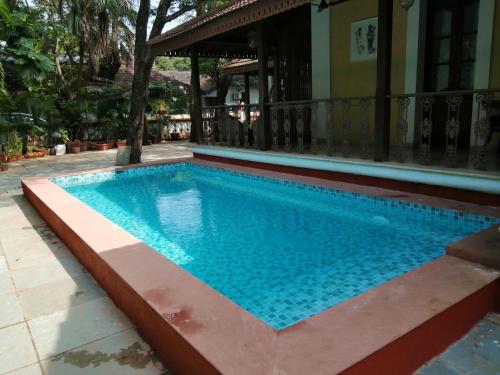 a swimming pool in the middle of a house at Surya Kiran Heritage Hotel in Panaji