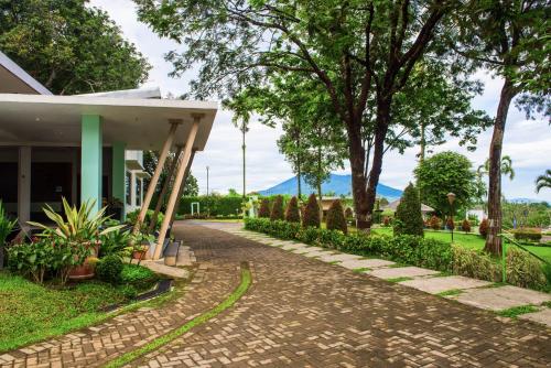a walkway in front of a house with trees at D'Agape Meeting & Conference in Puncak