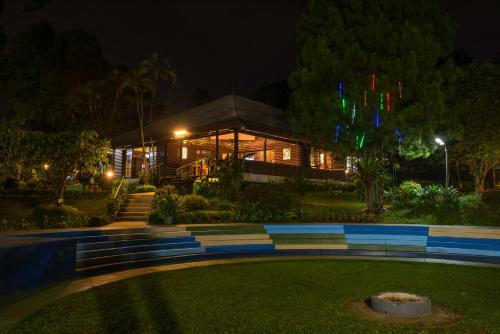 a building at night with a lawn in front of it at D'Agape Meeting & Conference in Puncak