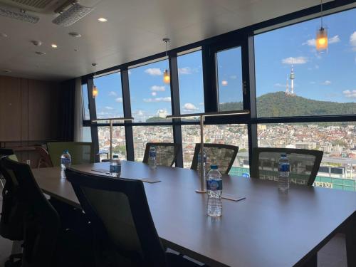 a meeting room with two bottles of water on a table at Hotel The Designers Seoul Station in Seoul