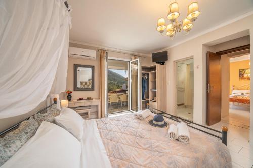 a bedroom with a large bed with shoes on it at Minas Apartments in Divarata