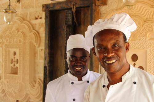 two chefs standing next to each other in a kitchen at The Charming Lonno Lodge Watamu in Watamu