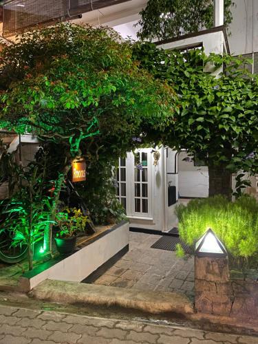 a front door of a house with plants and lights at Beach Walk Hotel Unawatuna in Unawatuna