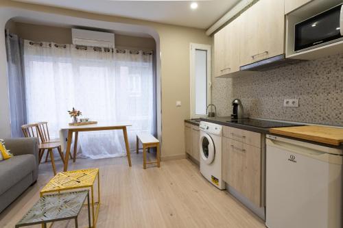 a kitchen and living room with a couch and a table at SF Avenue Santander in Santander