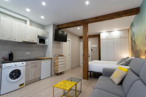 a living room with a couch and a bed in a room at SF Avenue Santander in Santander