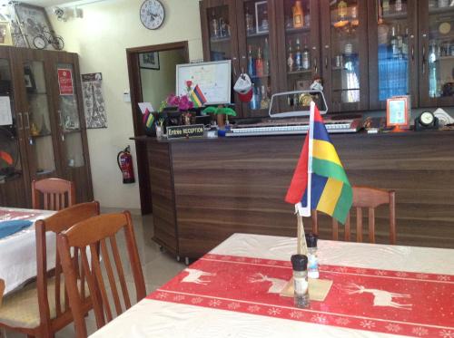 a table with a flag on top of a table at Luxor Residence Guesthouse in Belle Mare