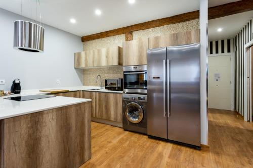 a kitchen with a stainless steel refrigerator and a dishwasher at SF Avenue Santander in Santander