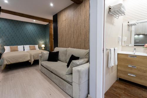 a living room with a couch and a bed at SF Avenue Santander in Santander