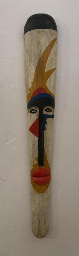 a wooden vase with a portrait of a woman on a wall at Eleven Pearl Boutique Hotel & Spa in Diani Beach