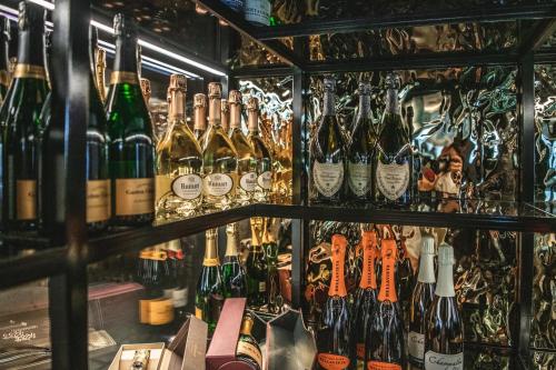 a bunch of bottles of wine in a bar at Alpin Garden Luxury Maison & SPA - Adults Only in Ortisei