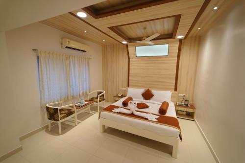 a bedroom with a bed with two animals on it at Hotel Palmyra Grand Inn in Tirunelveli
