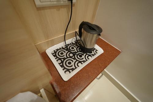 a trash can sitting on a counter in a room at Hotel Palmyra Grand Inn in Tirunelveli