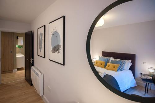 a bedroom with a bed with a mirror on the wall at Apartment 293 - Clifden in Clifden