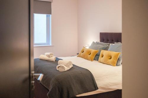 a bedroom with a bed with towels on it at Apartment 293 - Clifden in Clifden