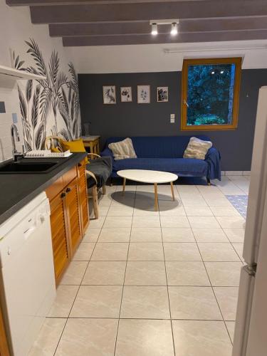 a kitchen and living room with a couch and a table at Les Gîtes du Goelo in Plouha