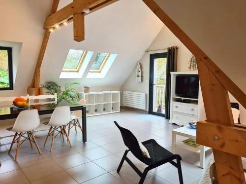 a living room with a dining table and chairs at Les Gîtes du Goelo in Plouha