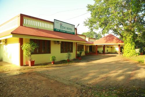 a building with a sign on the front of it at KTDC Tamarind Kondotty in Kondotti