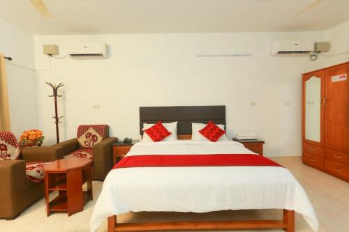 A bed or beds in a room at KTDC Tamarind