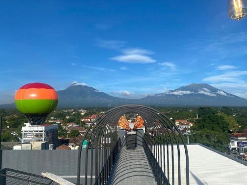 a bridge over a city with mountains in the background at MaxOneHotels Loji Kridanggo @Boyolali in Boyolali