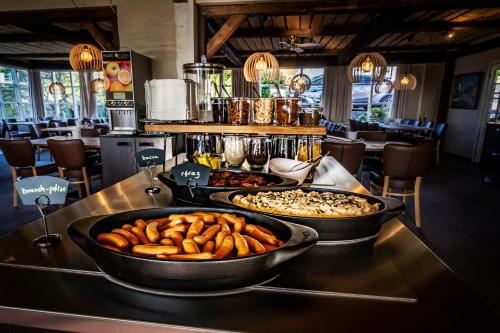 a buffet of food on a table in a restaurant at Hotel Allinge in Allinge