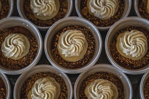 a bunch of cupcakes with whipped cream on them at Hotel Allinge in Allinge