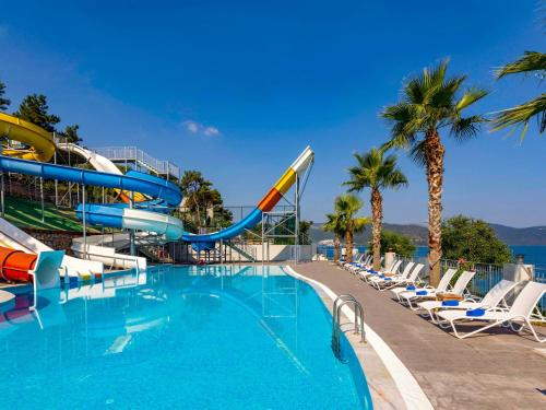 a pool at a resort with a water slide at Blue Dreams Resort Bodrum - Aquapark & Ultra All Inclusive in Torba