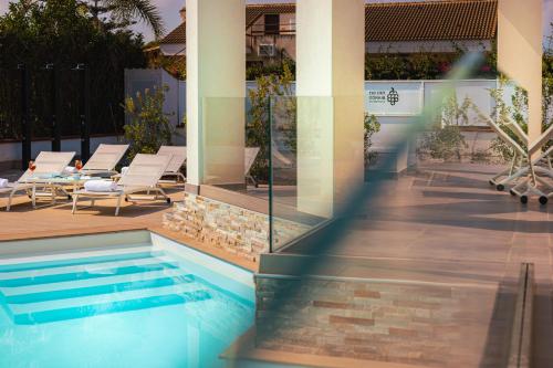 a swimming pool in the middle of a building at Gelso Bianco Apartments in Campofelice di Roccella