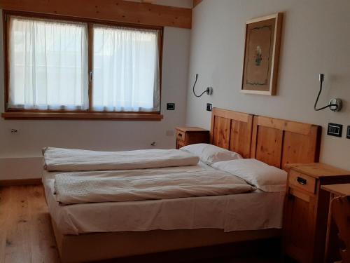 Un ou plusieurs lits dans un hébergement de l'établissement Hotel Moena
