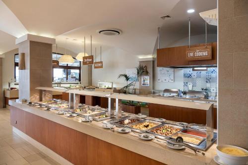 a buffet line with a lot of trays of food at Caldera Creta Paradise in Plataniás