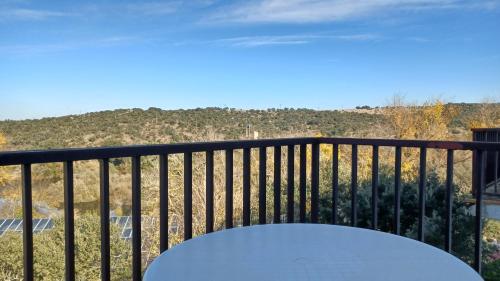 a table on a balcony with a view at Apartamentos Baños de Ledesma in Salamanca
