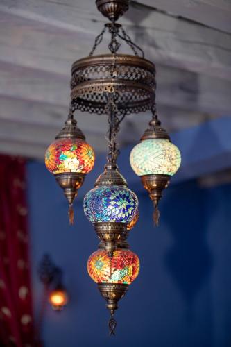 a chandelier with colorful lights hanging from a ceiling at Fatma Hanoum boutique hotel in Rhodes Town