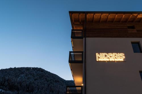 a sign on the side of a building at Nidaris - Luxury Private Spa Suites in Malè