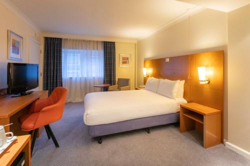 a hotel room with a bed and a television at Holiday Inn London - Regent's Park, an IHG Hotel in London