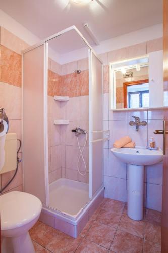 a bathroom with a shower and a sink and a toilet at Apartment Mužić in Cres