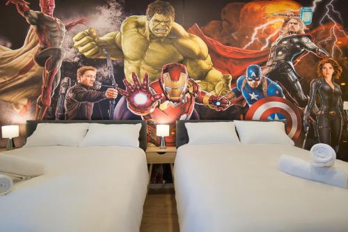a room with two beds and a superhero mural at Dreamy Stays Accommodation - Private Rooms with Shared Bathrooms in Adelaide