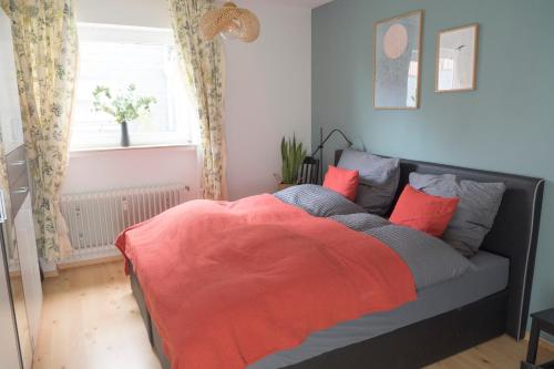 a bedroom with a bed with an orange blanket at Ferienapartment Landwohnung Theresa in Winterberg