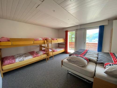a room with two bunk beds and a window at Ferienhaus Relax in Schwarzsee