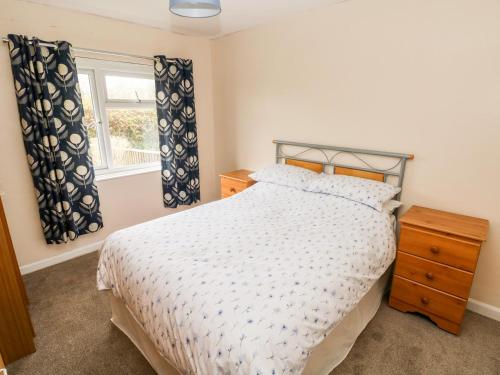 a bedroom with a bed and a window at 7 West Haven in Roch