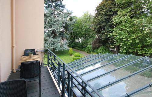 a balcony with a view of a yard at Le Manoir de la mantille in Caudry