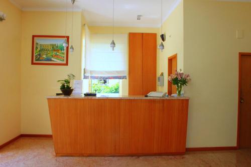 a lobby with a reception desk in a room at Hotel Caldelas in Caldelas