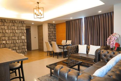 a living room with a couch and a table at V20 Boutique Jacuzzi Hotel in Bangkok