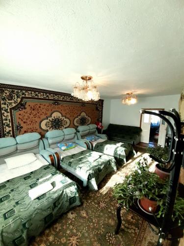 a living room with a couch and pillows at Guesthouse Kishimzhan in Talas