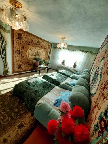 a bedroom with a large bed with red flowers on it at Guesthouse Kishimzhan in Talas