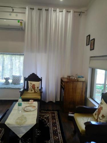 a living room with a couch and a table at Tranquility homestay in Shivpurī