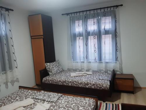 a bedroom with two beds and a window at Seosko turističko domaćinstvo Stojković in Aleksinac