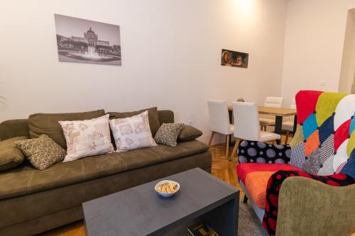 a living room with a couch and a table at Frui Centro Zagreb in Zagreb