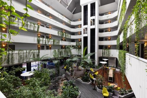 arium of a building with plants and trees at Novotel Darwin CBD in Darwin