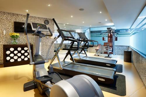 a gym with several tread machines in a room at Melia Barcelona Sarriá in Barcelona